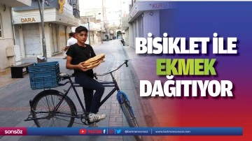 Bisiklet ile ekmek dağıtıyor